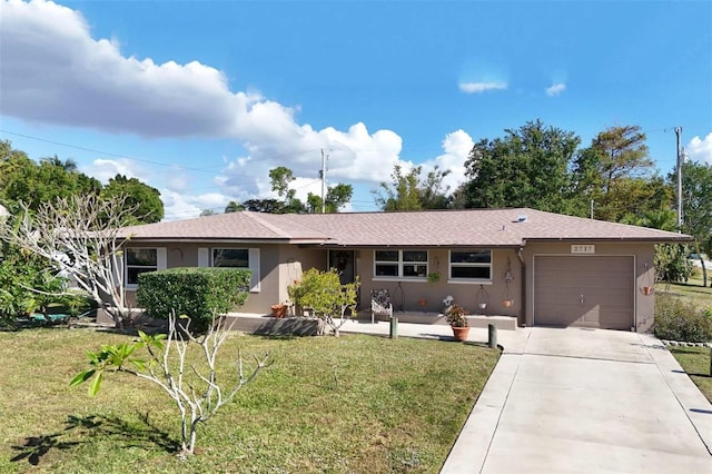 ranch-style home featuring a garage and a front yard