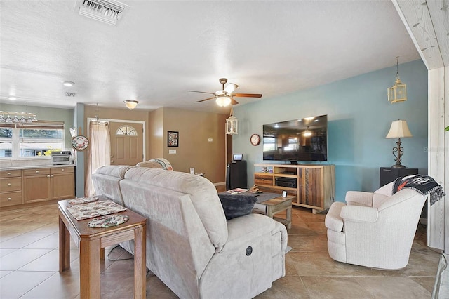 tiled living room with ceiling fan