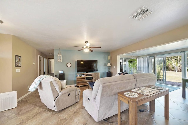 living room with ceiling fan and light tile patterned flooring