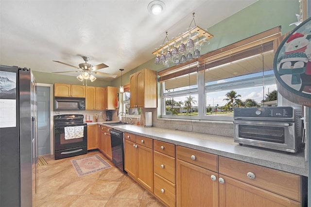 kitchen featuring black appliances, sink, ceiling fan, light tile patterned floors, and decorative light fixtures