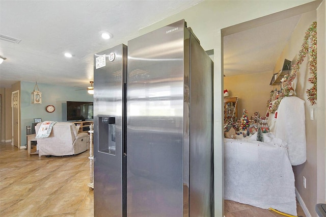 kitchen featuring ceiling fan and stainless steel refrigerator with ice dispenser