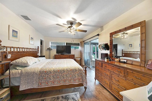 bedroom with tile patterned flooring, a textured ceiling, and ceiling fan