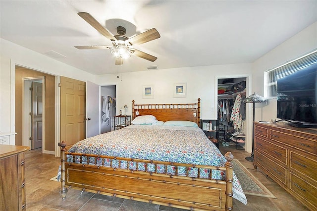 bedroom featuring ceiling fan, a closet, and a spacious closet