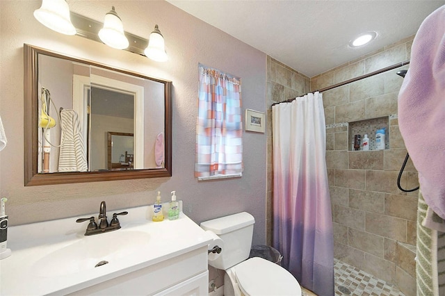 bathroom featuring vanity, curtained shower, and toilet