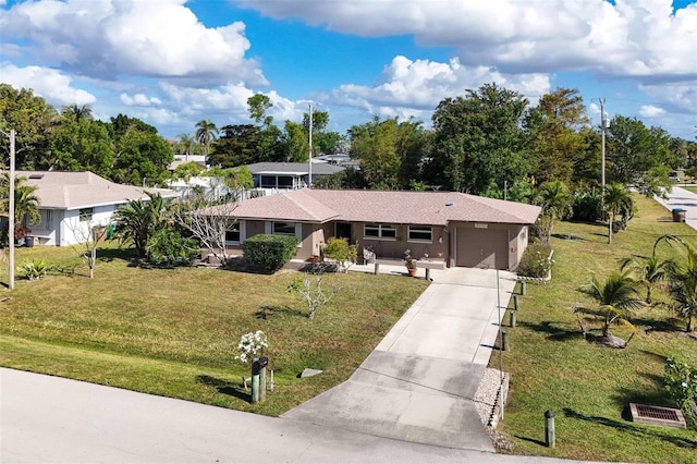 ranch-style home featuring a garage and a front lawn