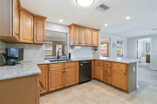 kitchen featuring kitchen peninsula, light stone countertops, sink, and black dishwasher