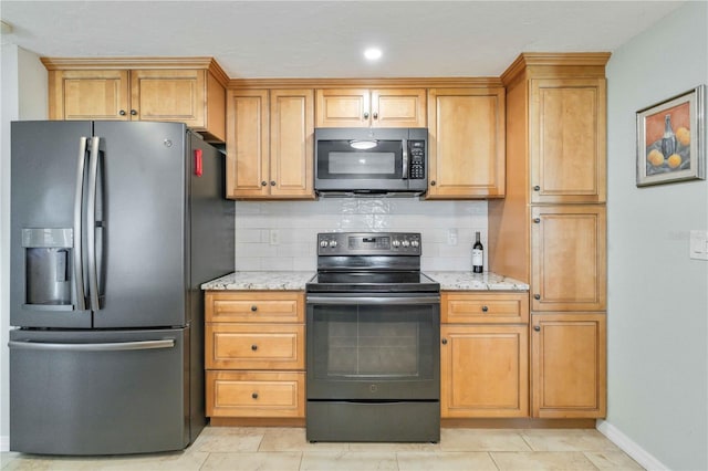 kitchen with decorative backsplash, stainless steel fridge, electric range, and light stone counters