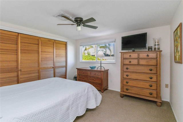 carpeted bedroom featuring a closet and ceiling fan