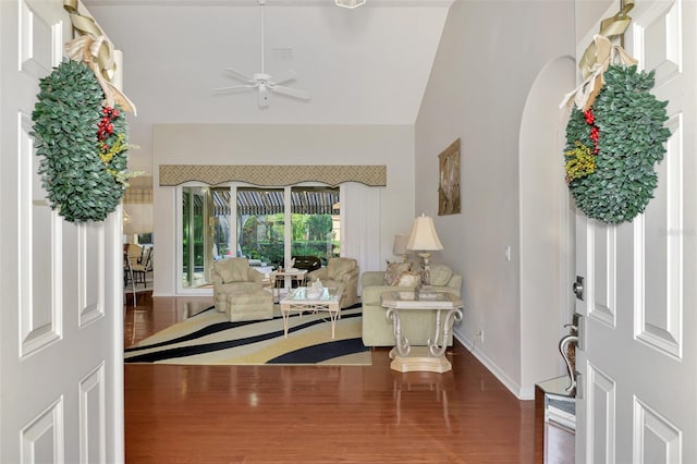 foyer entrance with dark hardwood / wood-style floors, ceiling fan, and vaulted ceiling