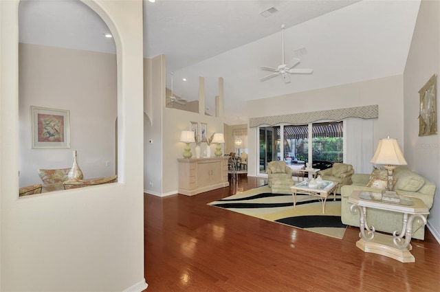 living room with ceiling fan, dark wood-type flooring, and lofted ceiling