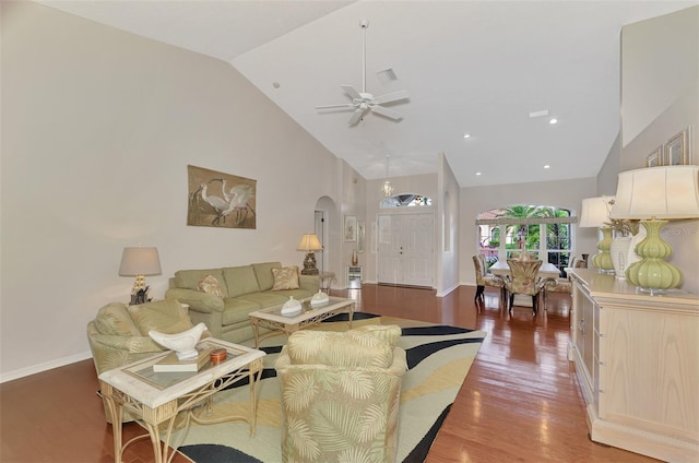 living room with dark hardwood / wood-style flooring, high vaulted ceiling, and ceiling fan