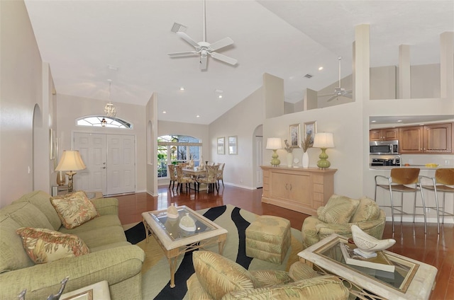 living room featuring ceiling fan, high vaulted ceiling, and dark hardwood / wood-style floors