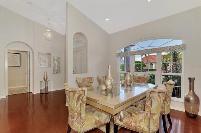 dining area with dark hardwood / wood-style flooring and high vaulted ceiling