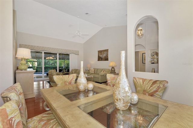 dining space with ceiling fan, high vaulted ceiling, and hardwood / wood-style flooring