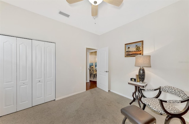 sitting room featuring carpet and ceiling fan