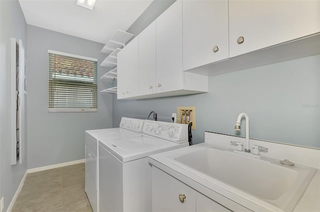 laundry area featuring cabinets, separate washer and dryer, sink, and light tile patterned floors