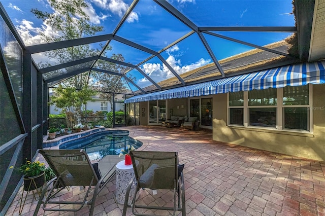 view of pool with glass enclosure, a patio area, a jacuzzi, and an outdoor hangout area