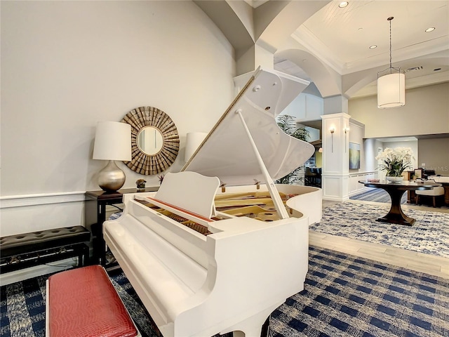 misc room with hardwood / wood-style floors and a high ceiling