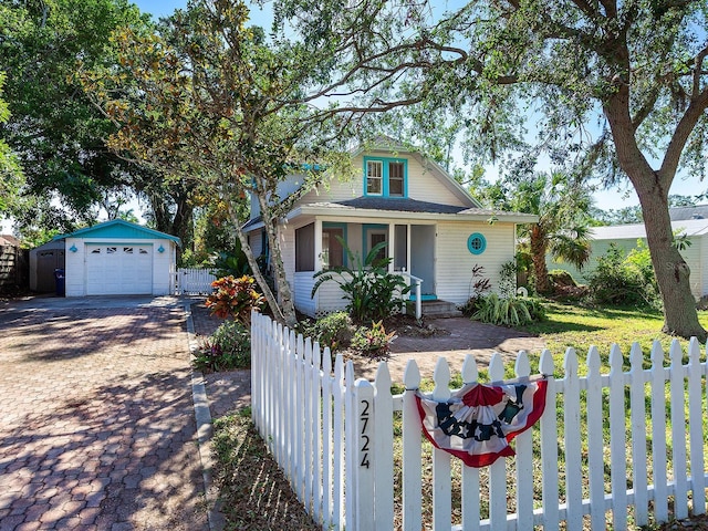 view of front of home with an outbuilding, a porch, and a garage