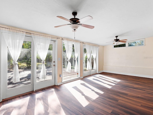 2724 Ashton Rd, Sarasota, FL 34231 - empty room featuring healthy amount of natural light, a ceiling fan, wood finished floors, and baseboards