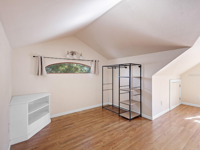2724 Ashton Rd, Sarasota, FL 34231 - unfurnished bedroom featuring lofted ceiling, light wood-style floors, and baseboards