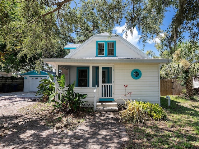 2724 Ashton Rd, Sarasota, FL 34231 - bungalow-style home with entry steps and an outbuilding