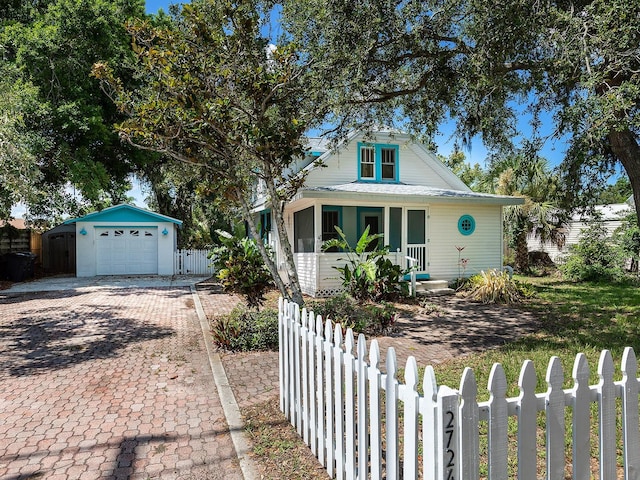 2724 Ashton Rd, Sarasota, FL 34231 - bungalow-style house featuring a fenced front yard, driveway, and a detached garage