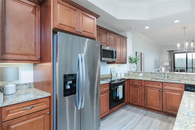 kitchen featuring an inviting chandelier, black appliances, sink, hanging light fixtures, and light stone counters