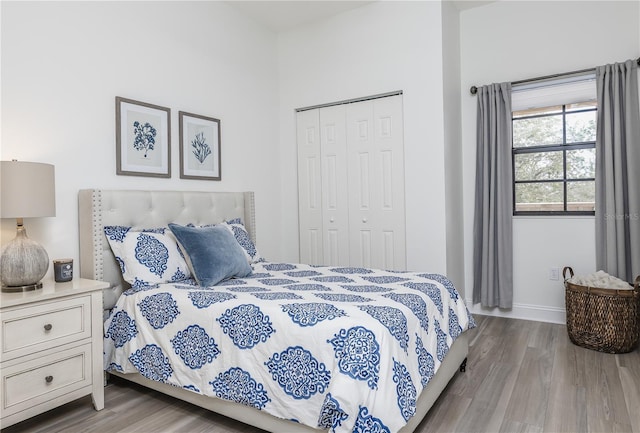 bedroom featuring light hardwood / wood-style floors and a closet