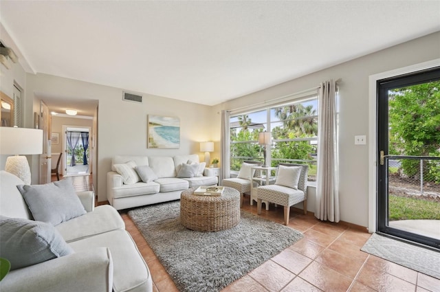 living room with a healthy amount of sunlight and light tile patterned floors