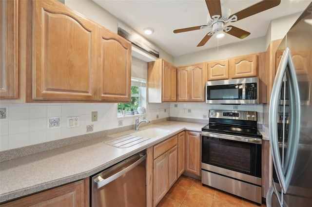 kitchen with backsplash, ceiling fan, light tile patterned flooring, and appliances with stainless steel finishes