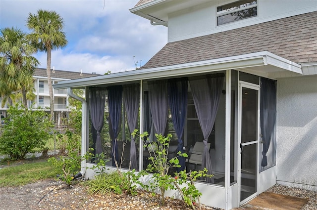 view of side of property featuring a sunroom