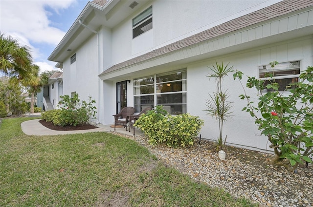 view of side of home featuring a lawn