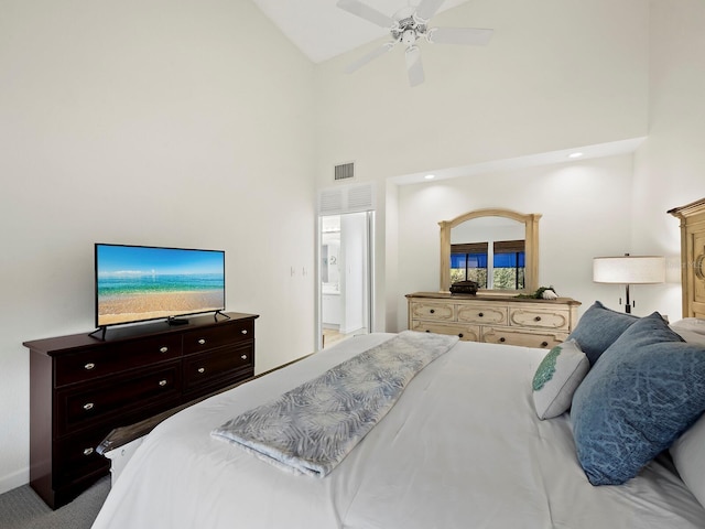 carpeted bedroom featuring ceiling fan and high vaulted ceiling