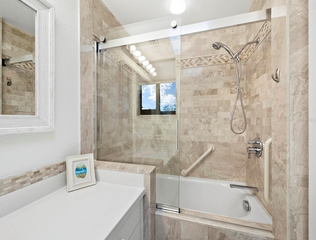 bathroom with bath / shower combo with glass door and vanity