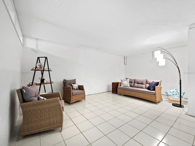 living room featuring a textured ceiling and light tile patterned floors