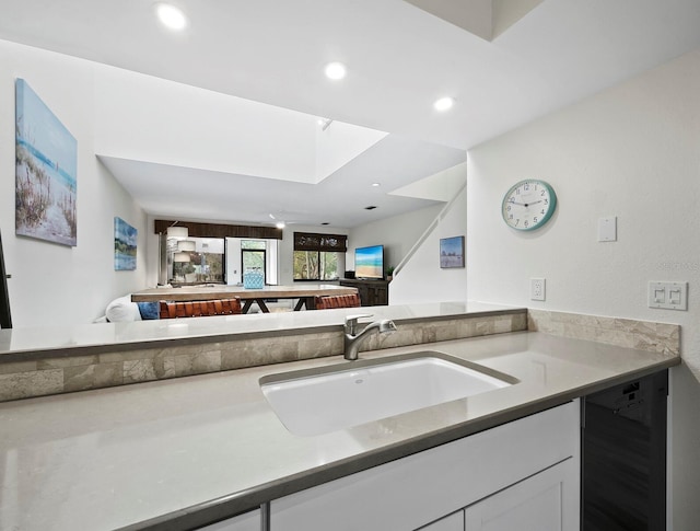 bathroom featuring sink and wine cooler