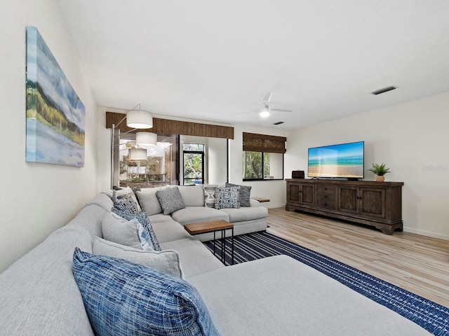 living room featuring ceiling fan and wood-type flooring