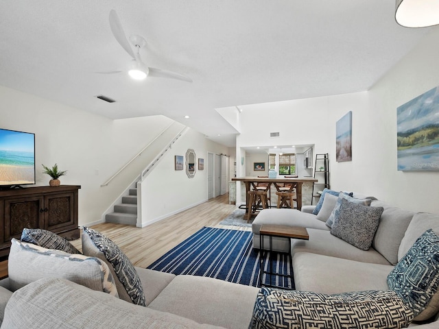 living room with ceiling fan and light hardwood / wood-style floors