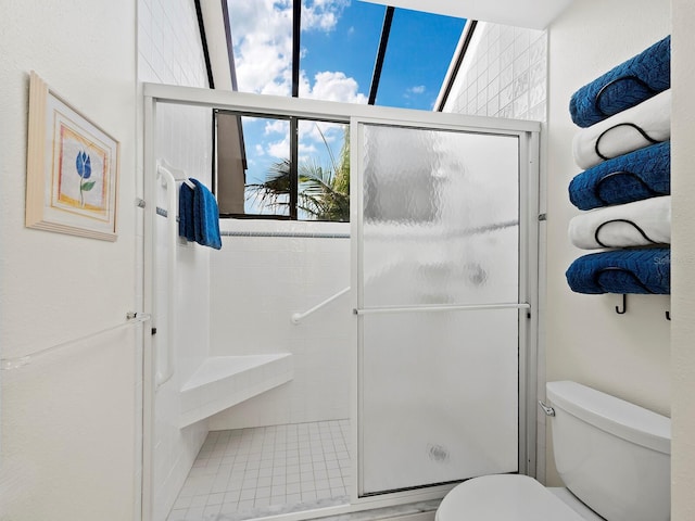 bathroom featuring toilet, a wealth of natural light, and an enclosed shower