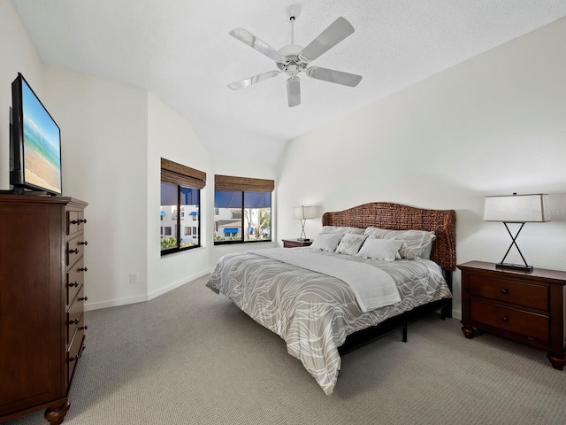 carpeted bedroom featuring ceiling fan, a textured ceiling, and lofted ceiling