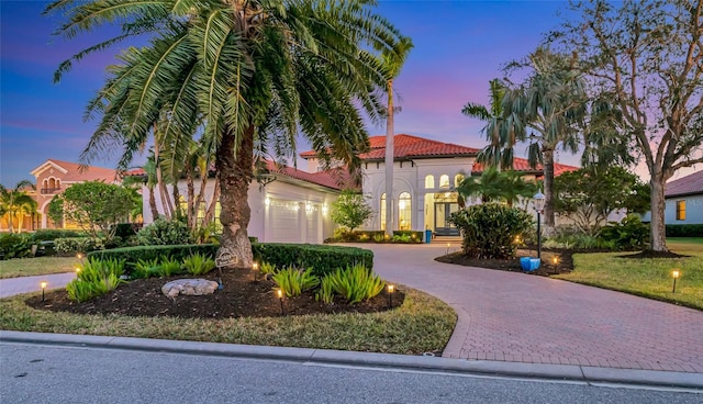 mediterranean / spanish home with a garage