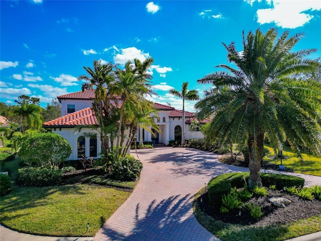 mediterranean / spanish-style house featuring a front lawn