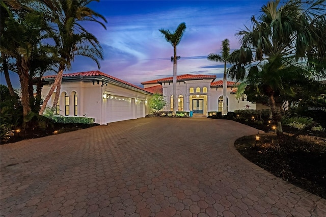 mediterranean / spanish-style house featuring french doors and a garage