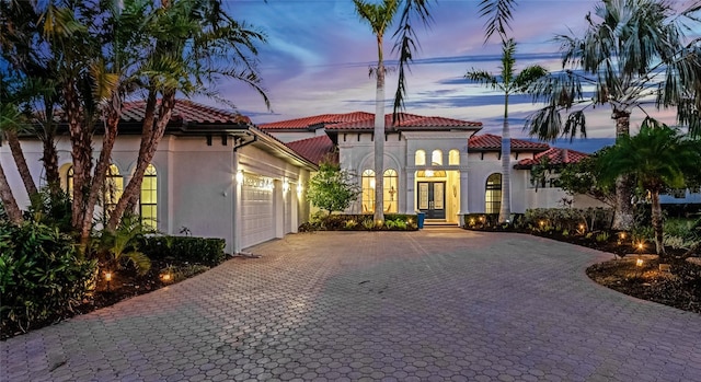 mediterranean / spanish-style house featuring french doors and a garage