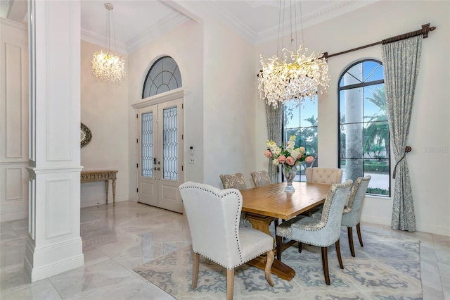 dining room featuring decorative columns, ornamental molding, french doors, and an inviting chandelier