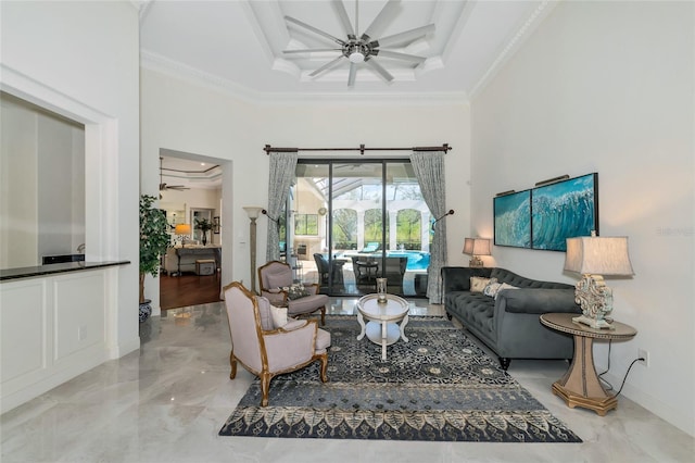 living room featuring ceiling fan and ornamental molding