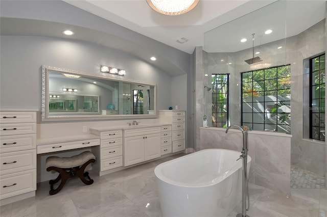 bathroom with plus walk in shower, vanity, and tile walls