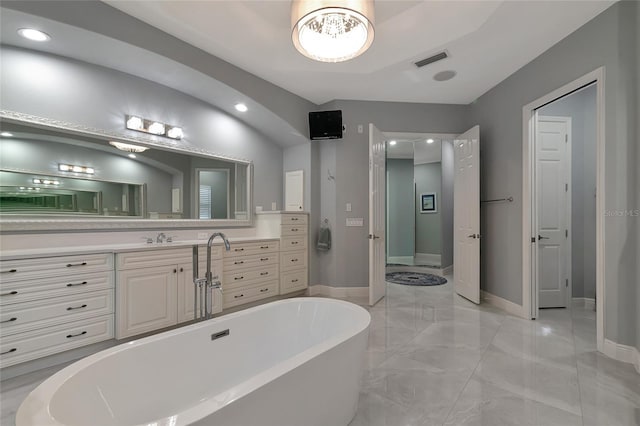 bathroom with vanity and a bath