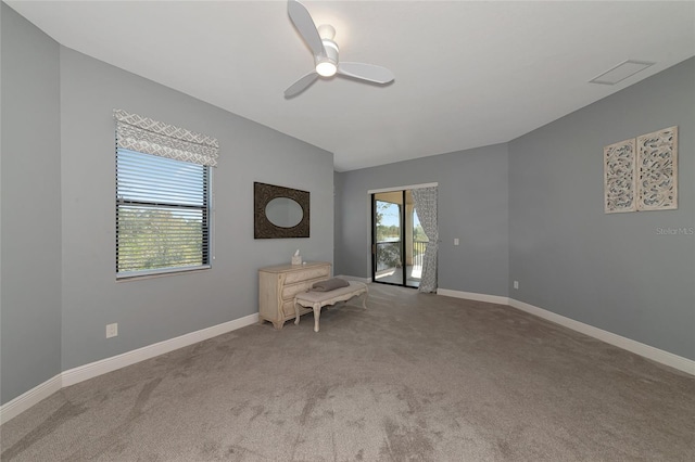 unfurnished room featuring ceiling fan and light colored carpet